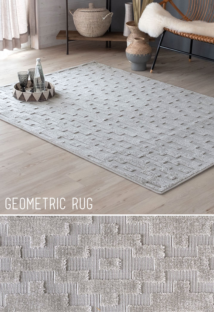 カットしたパイルで浮き上がったような柄を作り出したライトグレーのジオメトリック柄ラグ